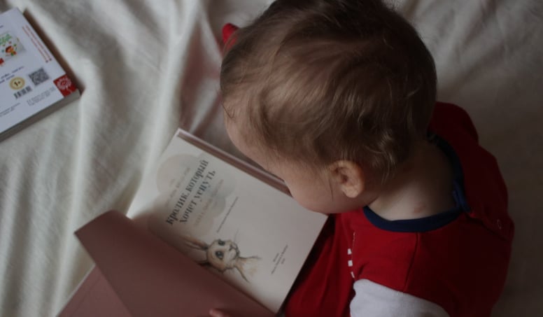 A Child Seeing At A Picture In A Book