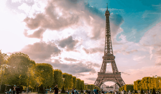 A Large Group Of Tourists Near Eiffel Tower In Paris