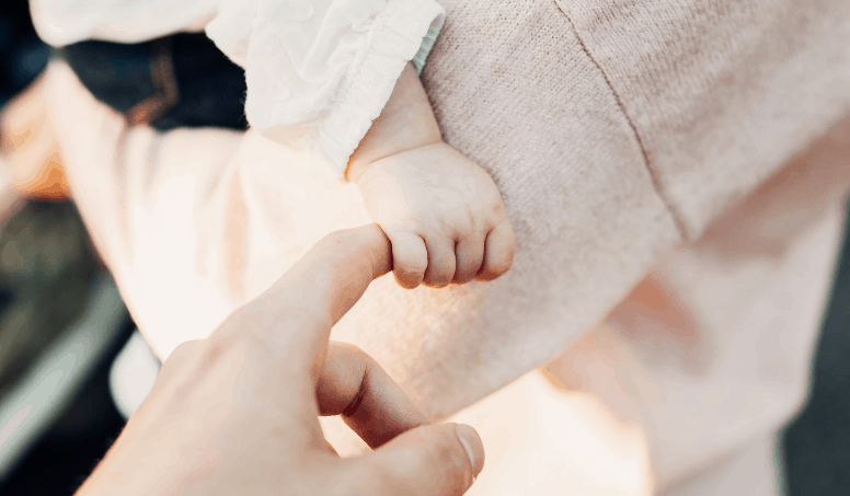 Baby Holding Hand Of Mother